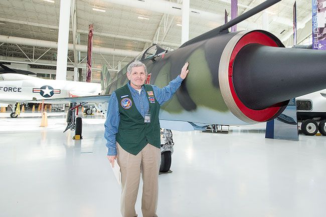 Marcus Larson/News-Register##Kurt Gibson-Zeigler, who recently joined the ranks of docents at the Evergreen Aviation Museum, shows off a MIG fighter jet similar to the one he flew in India. A Royal Air Force pilot, he spent time 
on an exchange in India that happened to coincide with the 1971 Indo-Pakistani War.