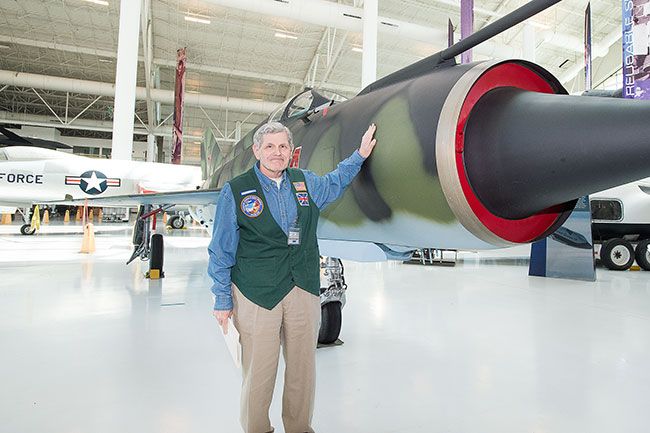 Marcus Larson/News-Register##Kurt Gibson-Zeigler, who recently joined the ranks of docents at the Evergreen Aviation Museum, shows off a MIG fighter jet similar to the one he flew in India. A Royal Air Force pilot, he spent time 
on an exchange in India that happened to coincide with the 1971 Indo-Pakistani War.