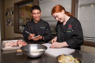 Rusty Rae/News-Register ## 
Allen Fernandez and Ire Staten practice preparing a meal in their culinary classroom at McMinnville High School. Both qualified for the national SkillsUSA competition, which they will attend in mid-June.
