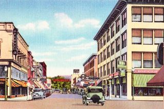 ##A hand-tinted postcard image of downtown Medford as it appeared in the late 1920s, when the Jackson County Rebellion was first beginning to brew.
