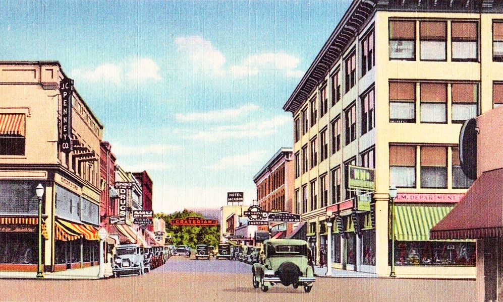 ##A hand-tinted postcard image of downtown Medford as it appeared in the late 1920s, when the Jackson County Rebellion was first beginning to brew.