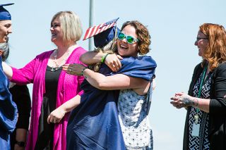 Marcus Larson / News-Register##Sheridan High teacher Carole Ashworth shares an emotional hug with her niece, Alyssa Campbell, moments after Alyssa received her diploma. Marcus Larson / News-Register##Sheridan High teacher Carole Ashworth shares an emotional hug with her niece, Alyssa Campbell, moments after Alyssa received her diploma.