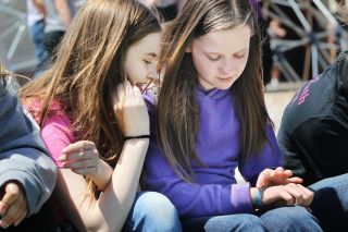Rockne Roll/News-Register##Kaylee Williams, right, shows classmate Ashley Dickens her media alert bracelet during recess at Yamhill-Carlton Intermediate School. Kaylee was recently diagnosed with diabetes.