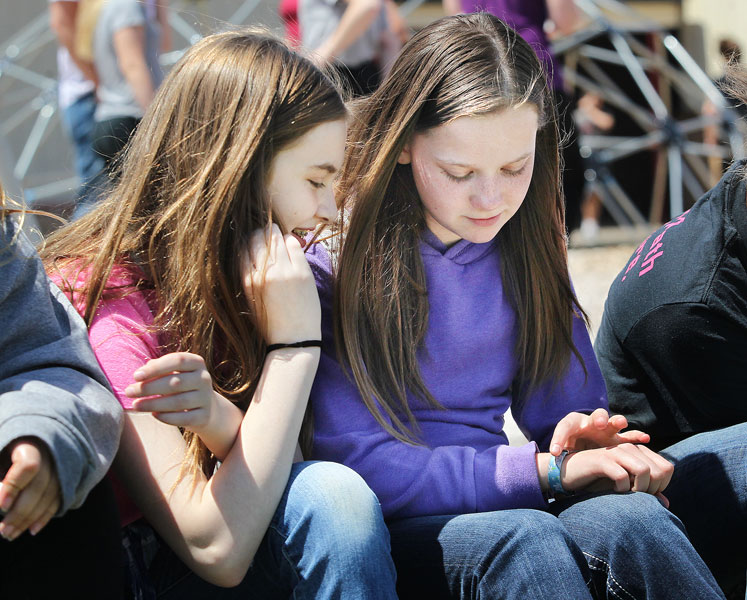 Rockne Roll/News-Register##Kaylee Williams, right, shows classmate Ashley Dickens her media alert bracelet during recess at Yamhill-Carlton Intermediate School. Kaylee was recently diagnosed with diabetes.