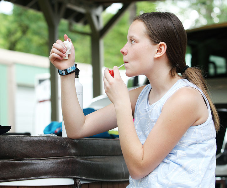 Rockne Roll/News-Register##Kaylee sips juice at home after playing basketball with her older brother for a little over a half hour. A low blood sugar reading on her monitor forced her to take a juice break.