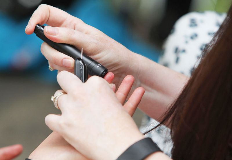 Rockne Roll/News-Register##Kelly Williams pricks her daughter’s finger for a blood glucose test. Kaylee’s blood must be tested five to 10 times a day.