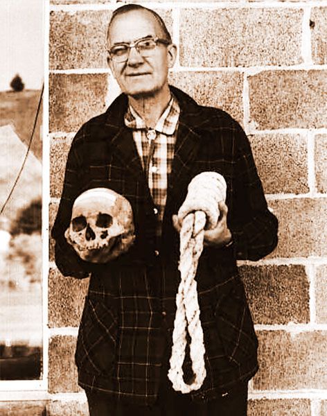 Ben Maxwell/ Salem Public Library##Howard A. Black, curator at Grant County Museum in Canyon City, Oregon, holds the skull of Berry Way and a “California collar,” or noose, of the type Way was hanged with, in this 1963 photograph.