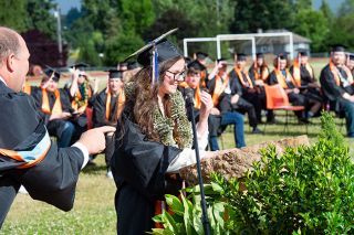 Rusty Rae/News-Register ##
Principal Clint Raever congratulates Laticia Garcia, one of the salutatorians, as she begins her speech during Yamhill Carlton High School’s graduation Sunday afternoon. Rusty Rae/News-Register ##
Principal Clint Raever congratulates Laticia Garcia, one of the salutatorians, as she begins her speech during Yamhill Carlton High School’s graduation Sunday afternoon.