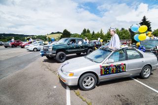 Marcus Larson/News-Register##Sheridan High graduate Devin Drader and others line up their cars in the Forest River RV plant parking lot for a drive-through ceremony on Saturday. Marcus Larson/News-Register##Sheridan High graduate Devin Drader and others line up their cars in the Forest River RV plant parking lot for a drive-through ceremony on Saturday.