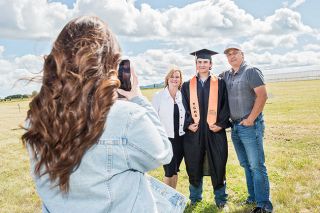 Rusty Rae/News-Register##YC High graduate Cody Brault and his parents, Tracy and Craig Brault, pose for a photo following the commence-ment ceremony held at Bailey Nurseries west of Yamhill. About 61 students graduated Sunday afternoon. Rusty Rae/News-Register##YC High graduate Cody Brault and his parents, Tracy and Craig Brault, pose for a photo following the commence-ment ceremony held at Bailey Nurseries west of Yamhill. About 61 students graduated Sunday afternoon.