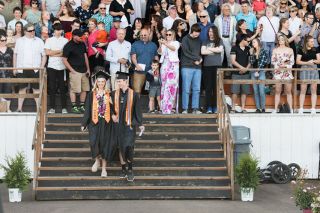 Rusty Rae/News-Register## Aylea Dixon and Joseph McGhehey walk down the stadium steps at the start of Yamhill-Carlton High s ommencement ceremony Sunday. McGhehey, who perched antlers on his mortarboard, was one of five valedictorians who spoke at graduation. Rusty Rae/News-Register## Aylea Dixon and Joseph McGhehey walk down the stadium steps at the start of Yamhill-Carlton High s ommencement ceremony Sunday. McGhehey, who perched antlers on his mortarboard, was one of five valedictorians who spoke at graduation.