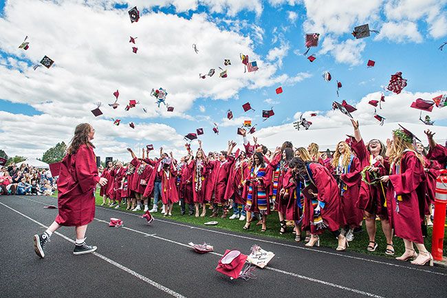 Marcus Larson/News-Register##
Dayton High School graduates toss their caps high in the air at the
conclusion of commencement ceremonies on Saturday.