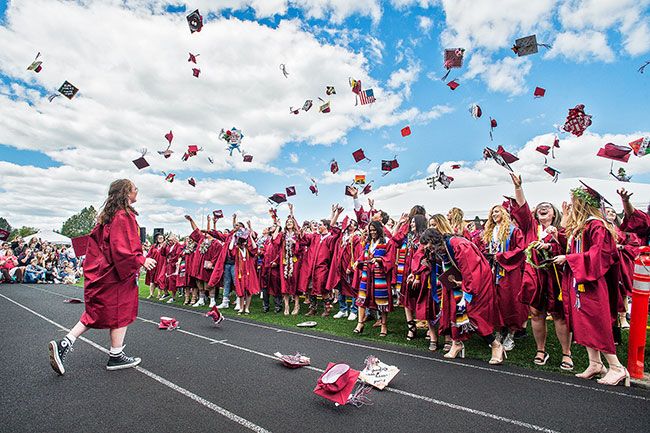 Marcus Larson/News-Register##
Dayton High School graduates toss their caps high in the air at the
conclusion of commencement ceremonies on Saturday.