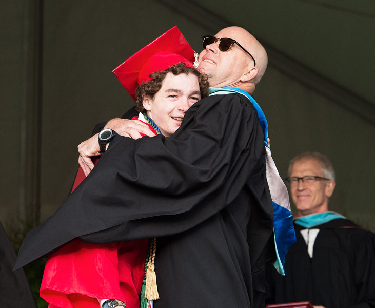 Marcus Larson / News-Register## McMinnville School Board member Carson Benner shares a hug with his son, Prescott, as the new graduate walks across the stage to receive his diploma.