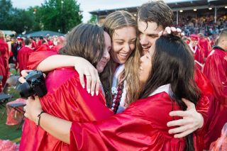 Marcus Larson/News-Register##
McMinnville High School graduates Madeline Gibson, Natalia Rentsch, Caleb Landis and Allison Robertson share a group hug at the conclusion of commencement.
