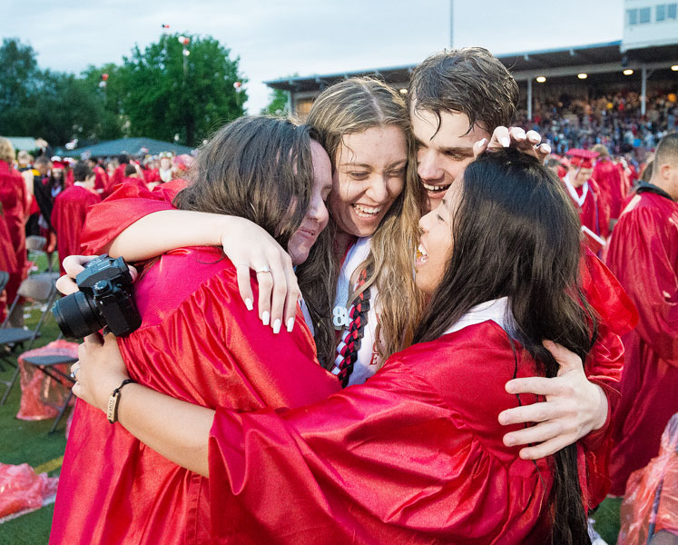 Marcus Larson/News-Register##
McMinnville High School graduates Madeline Gibson, Natalia Rentsch, Caleb Landis and Allison Robertson share a group hug at the conclusion of commencement.