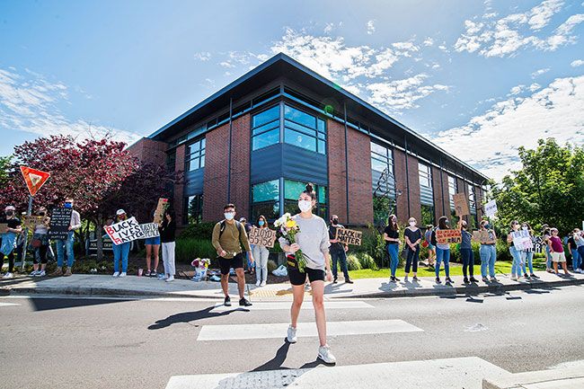 Marcus Larson/News-Register ## McMinnville High School senior Cecilia Flores, center, outside the McMinnville Police Station last week during a protest she organized with the help of several friends.