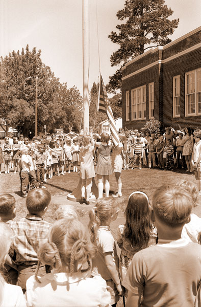 ##(June 10, 1970) Columbus School students planned an unusual flag-lowering ceremony Friday to signal the end of school this year, as part of  regular closing day exercises. Girls from the sixth grade who organized the ceremony were Kathy Fritz, Kristi Roberts, Patty Olson and Phyllis Reyne.