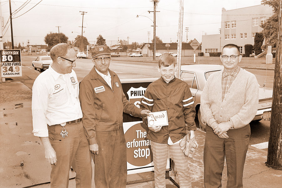 (June 10, 1970) Dick Barker and Sid Johnston, local distributor and dealer for the Phillips Petroleum Co., present Doug Dix with his award for winning the divisional competition in the pitch, hit and throw competition as father Merle looks on. All four will now get a free ride to Oakland, where Doug will be throwing in regional competition. lf he wins there, he’ll go on to the national competition in Cincinnati during the All-Star game.