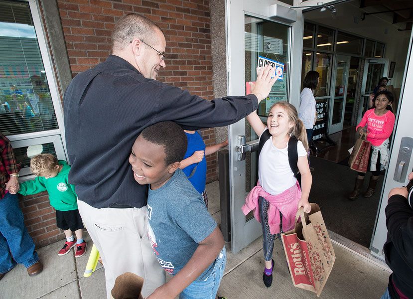 Marcus Larson / News-Register##Retiring Newby Elementary Principal Dave Carlson says goodbye to students as they leave for the summer Thursday afternoon.