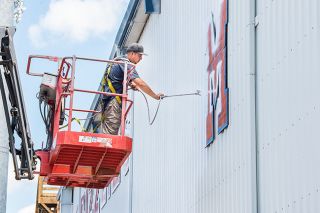 Marcus Larson/News-Register##
Jesse Perez with Spink Painting covers Wortman Stadium’s exterior with primer in preparation for a new coat of paint. Marcus Larson/News-Register##
Jesse Perez with Spink Painting covers Wortman Stadium’s exterior with primer in preparation for a new coat of paint.