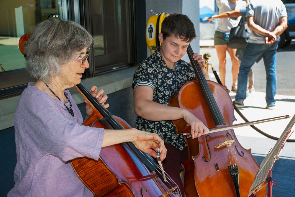Starla Pointer/News-Register##Cellists Sherill Roberts and Amelia Bierly perform for listeners in the Atticus Hotel courtyard during Make Music McMinnville on Tuesday.