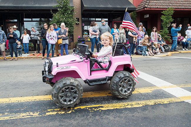 Marcus Larson/News-Register##
In the Carlton Fun Days parade, 1-year-old Brooklynn McQueen cruises by
in her pink remote controlled jeep.