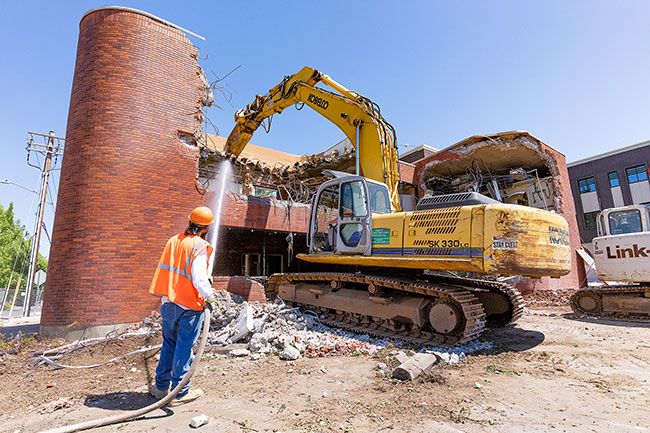 Marcus Larson/News-Register ##Workers raze the old First Federal headquarters at Third and Adams streets. The structure was built in the early 1970s. The new, three story building opened in early summer.