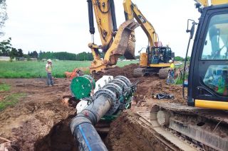 Workers for K&E Excavating install a 28-inch water transmission pipeline along Highway 18. It will carry water to the Lafayette pump station. Submitted photo.