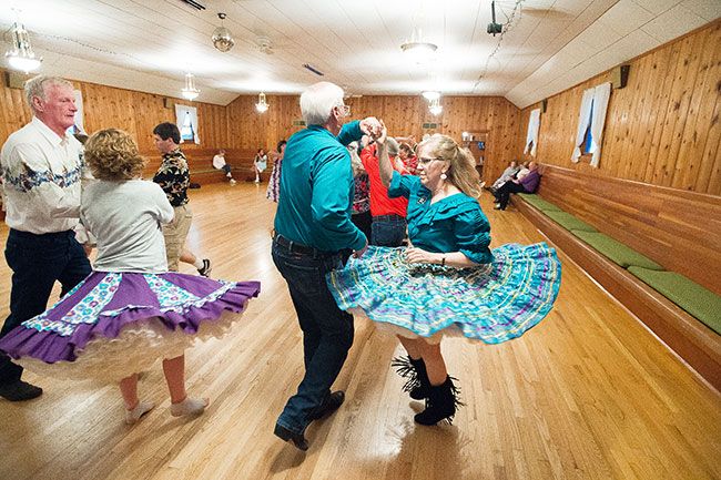 Marcus Larson/News-Register##Nate and Jennie Ramer partner at a Braids & Braves dance. Four couples form a square that moves according to directions from the caller.