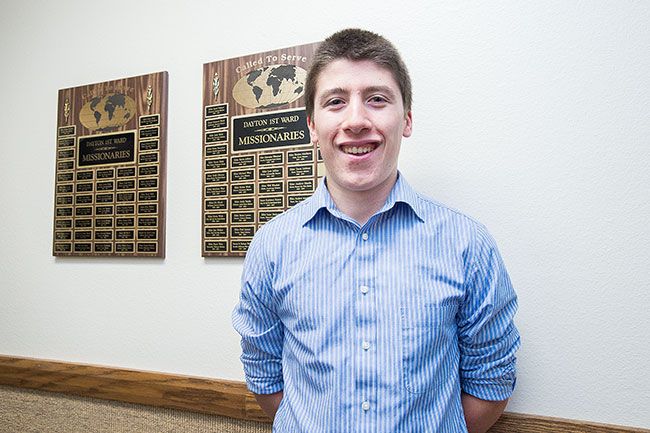 Marcus Larson/News-Register##Dayton graduate Dylan Blanchard poses for a portrait in front of two commemorative plaques listing the names of missionaries from his church. His name soon will join the list.