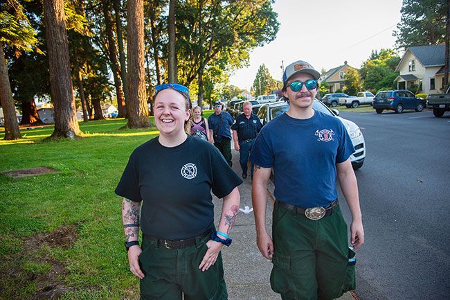 Kirby Neumann-Rea/News-Register##Dayton Fire Department members Naomi Sweet (who also serves Sheridan) and Harlan Rios, walk with Dayton Chief Bret Putnam and Matt and Jeannette Sweet, all part of a nine-member department team participating for the first time in Relay For Life.