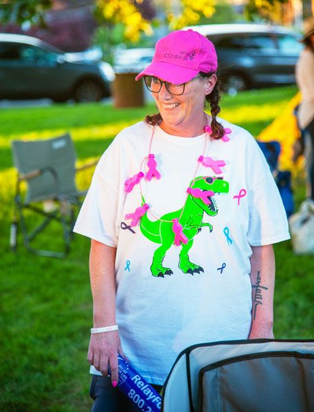 Kirby Neumann-Rea/News-Register##Relay for Life:
Survivor Melissa Gonzalez of McMinnville, decked in pink hat and necklace, pauses between playful jousts with her Power Forward teammates using her inflatable Relay for Life baton. The Memorial Elementary teacher said her entire school community has  been through a lot  with several staff members battling cancer.