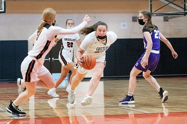 Rusty Rae/News-Register file photo##
McMinnville forward Kylee Arzner dribbles around a Sunset defender during the Grizzlies’ Culminating Week matchup against the Apollos. Arzner was recently named Player of the Year for the Class 6A Pacific Conference.