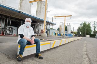 Rusty Rae/News-Register##Organic Valley Creamery plant manager Scott Fields rests on a new retaining wall at the McMinnville plant.