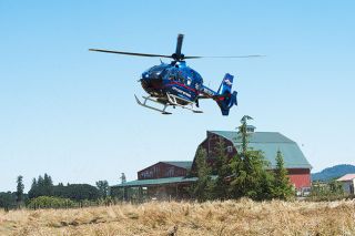 Marcus Larson/News-Register##
A Life Flight helicopter lifts off from the scene of a fatal collision on Highway 99W south of McMinnville Monday, July 3. Two helicopters and multiple ground ambulances were required to transport patients from the scene.