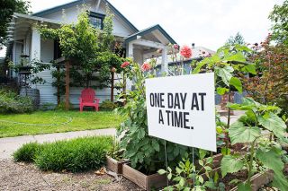 Rusty Rae/News-Register##A sign on McMinnville s 8th Street urges people to take  One Day at a Time. 