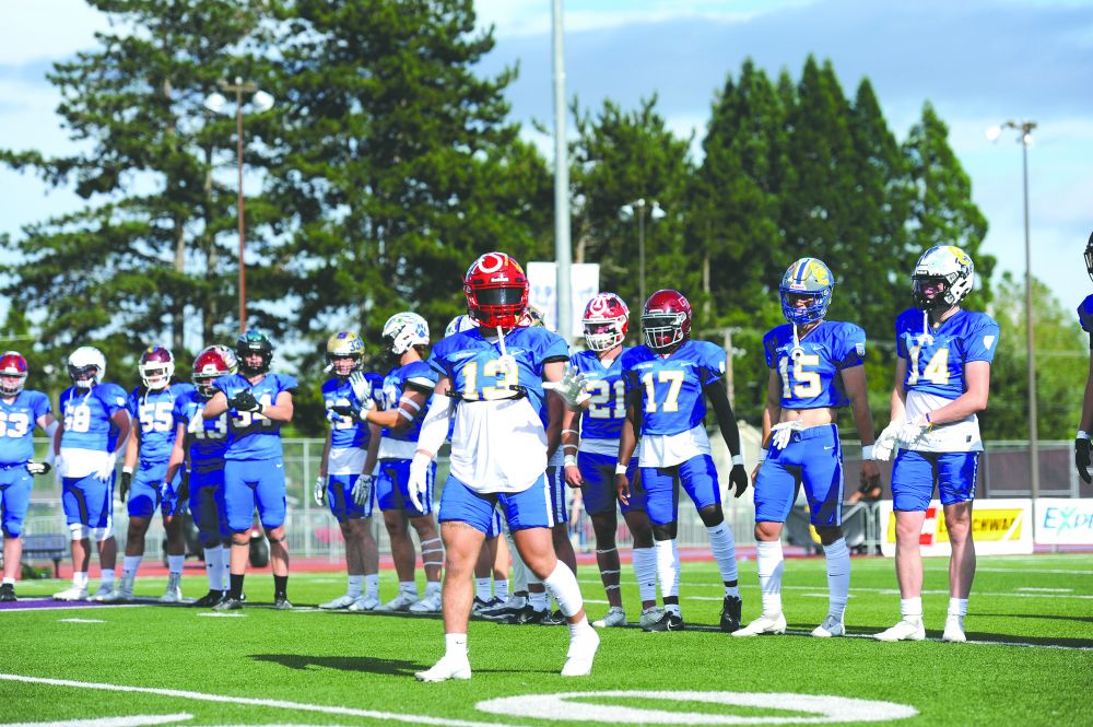 Logan Brandon/News-Register##
McMinnville defensive back Austin Rapp waves to fans during introductions of Saturday’s Les Schwab Bowl played at Linfield University’s Maxwell Field. Rapp and Team Columbia defeated Team Willamette, 28-9, in the all-star football showcase.