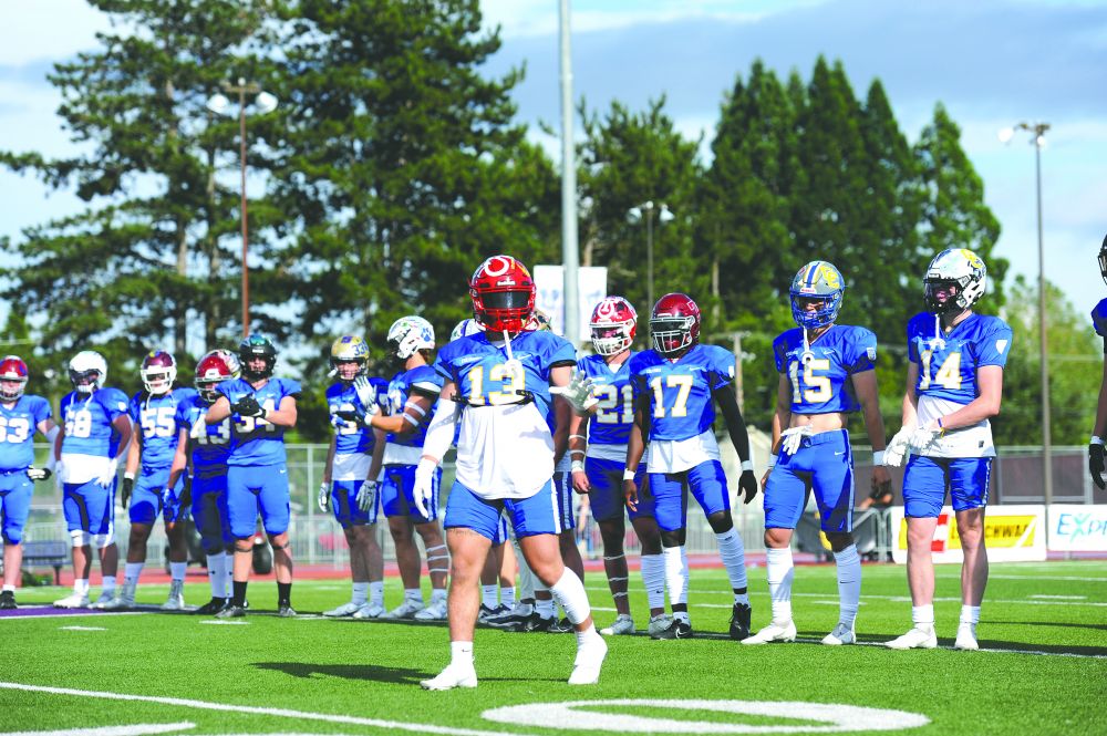 Logan Brandon/News-Register##
McMinnville defensive back Austin Rapp waves to fans during introductions of Saturday’s Les Schwab Bowl played at Linfield University’s Maxwell Field. Rapp and Team Columbia defeated Team Willamette, 28-9, in the all-star football showcase.