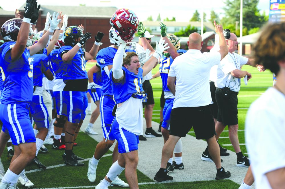 Logan Brandon/News-Register##
Austin Rapp of McMinnville celebrates a touchdown by Team Columbia during the first quarter of Saturday’s Les Schwab Bowl.