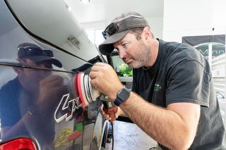 Marcus Larson/News-Register ## McMinnville Auto Detail owner Chris Lee uses an orbital polisher to remove light scratches and swirls from the paint on a customer’s truck. He will be applying his detailing skills to vintage aircraft next week. Marcus Larson/News-Register ## McMinnville Auto Detail owner Chris Lee uses an orbital polisher to remove light scratches and swirls from the paint on a customer’s truck. He will be applying his detailing skills to vintage aircraft next week.