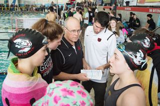 Marcus Larson/News-Register##McMinnville High School swim coaches Jason Hafner and Murilo Martins go over the game plan with members of the girls team, moments before the start of a race at the 2020 state
championships. Marcus Larson/News-Register##McMinnville High School swim coaches Jason Hafner and Murilo Martins go over the game plan with members of the girls team, moments before the start of a race at the 2020 state
championships.