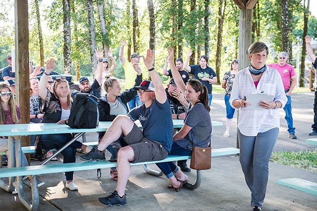 Rusty Rae/News-Register##Yamhill City Recorder Lori Gilmore (right) counts votes from the city s biennial caucus in July.