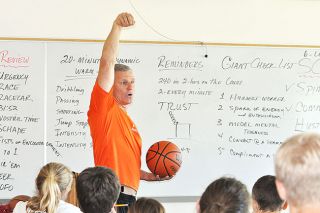 Robert Husseman/News-RegisterLarry Doty instructs campers on proper jumpshot follow-through during a classroom session.
