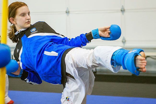 Rusty Rae/News-Register##
Jenna Martin, of Dayton, practices her high kick at Mendonca Academy. Martin also placed third in her 14-15 year-old kumite event.