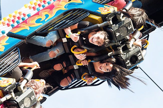 Marcus Larson/News-Register##
Kyann Boyce and Britney Billarreal scream with excitement as they enjoy a upside down ride at the Turkey Rama Carnival.