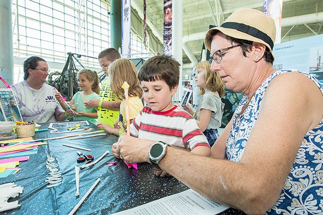 Marcus Larson/News-Register##
Robbie Porter helps her grandson, Levi Wyatt, 5, construct a paper
rocket during Evergreen Aviation Museum s Apollo 11 celebration. The
event marked the 50th anniversary of the moon landing.