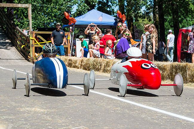 Marcus Larson/News-Register##
Soap box derby competitors Jackson Mitchell, left, and Brett Summers 
race down the track neck-and-neck during the Yamhill Derby Days festival.