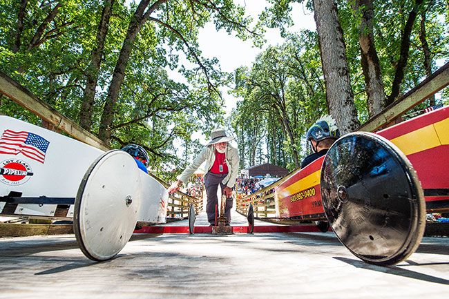 Marcus Larson/News-Register##
At the top of the soap box derby ramp, starter Jay Disbrow checks with
racers Kainan Knapp and Ryan Hoodenpyl to see if they are ready to begin
the race.