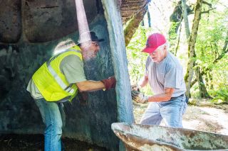 Marcus Larson / News-Register##Rotarians Mark Pauletto, left, and Dudley Frost use cement plaster to patch a hole in the mushroom structure in  Airport Park.